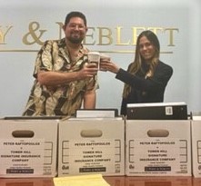 Perry & Neblett Win Jury Trial against Tower Hill Insurance Lawyers. $35,000 Paid plus expenses for the client. David Neblett, Esq. and Melissa Palau, Esq. with case files. 