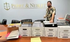 Perry & Neblett Win Jury Trial against Tower Hill Insurance Lawyers. $35,000 Paid plus expenses for the client. David Neblett, Esq. with case files. 